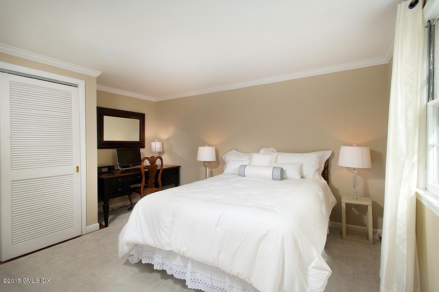 24 Meadow Road Riverside, CT 06878 - Photo 10 of 16 a bedroom with a bed and a flat screen tv