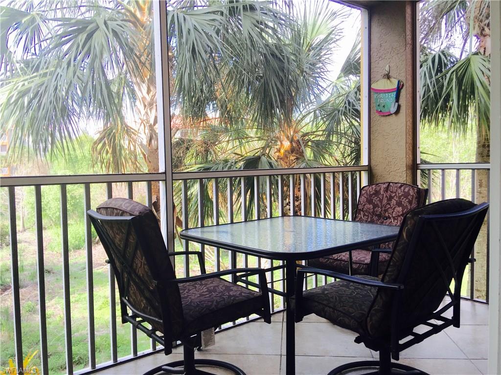 4530 Botanical Pl Circle, Unit 206 Naples, FL 34112 - Photo 1 of 25 a view of a balcony with furniture and a table