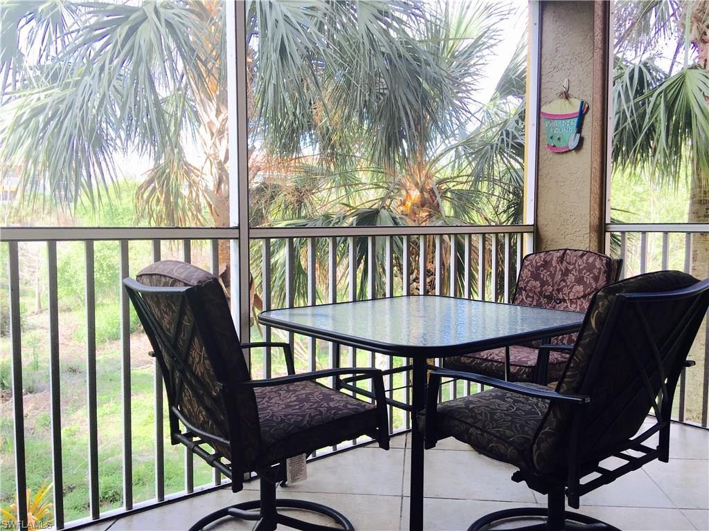 4530 Botanical Pl Circle, Unit 206 Naples, FL 34112 - Photo 17 of 25 a view of a balcony with furniture