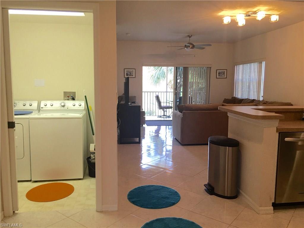 4530 Botanical Pl Circle, Unit 206 Naples, FL 34112 - Photo 2 of 25 a living room with a couch and a table