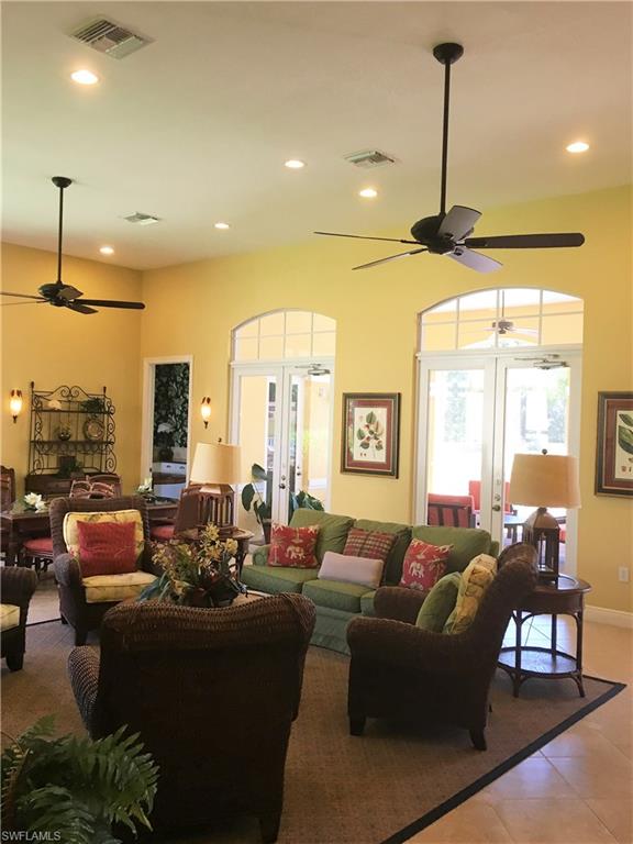 4530 Botanical Pl Circle, Unit 206 Naples, FL 34112 - Photo 21 of 25 a living room with furniture and a chandelier