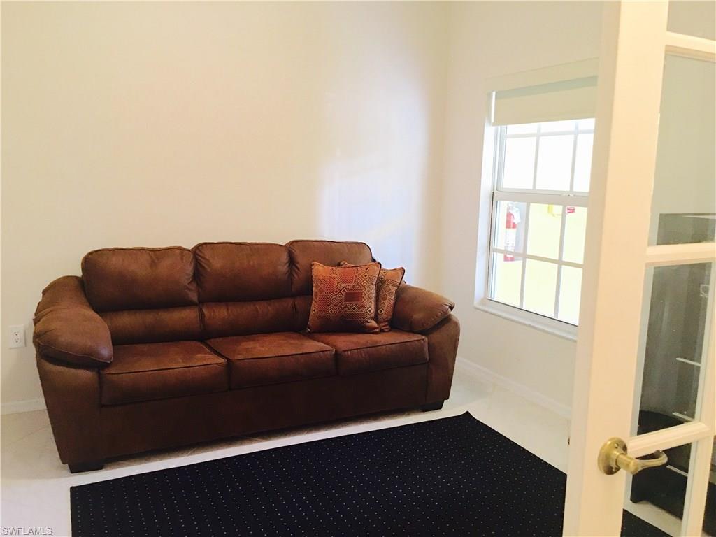 4530 Botanical Pl Circle, Unit 206 Naples, FL 34112 - Photo 3 of 25 a living room with furniture and a window