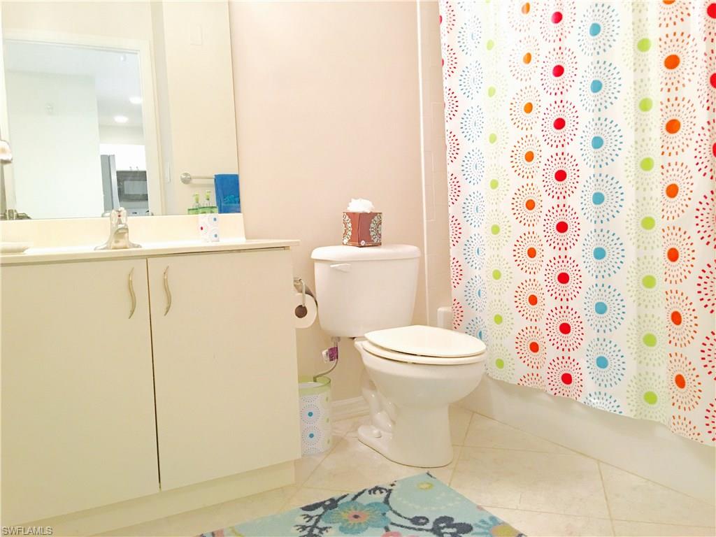 4530 Botanical Pl Circle, Unit 206 Naples, FL 34112 - Photo 6 of 25 a bathroom with a sink toilet and shower