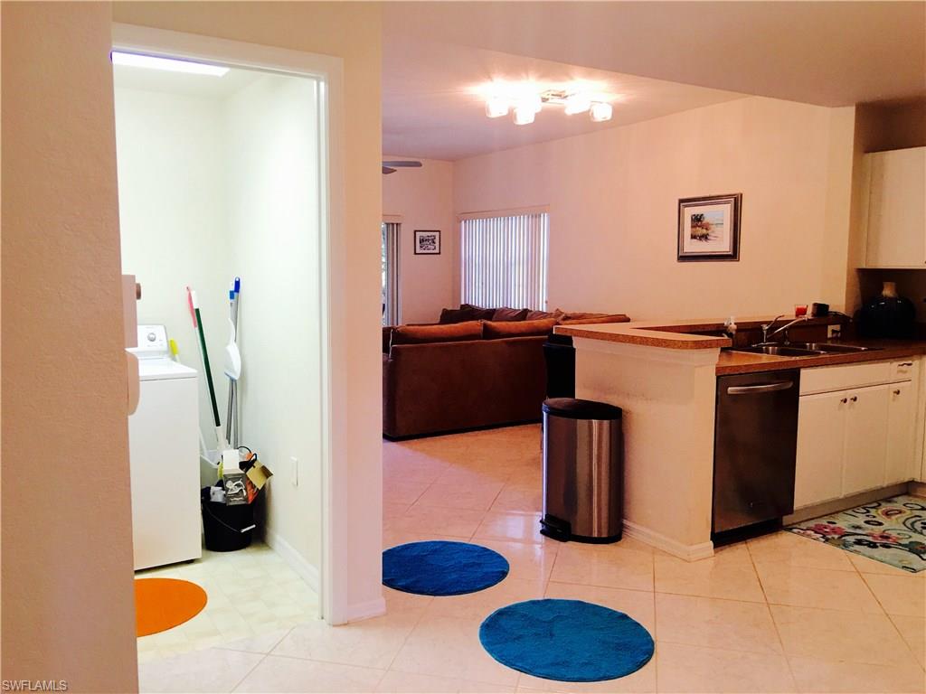 4530 Botanical Pl Circle, Unit 206 Naples, FL 34112 - Photo 7 of 25 a kitchen with a sink and a stove top oven