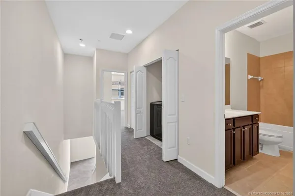 a view of kitchen with stainless steel appliances refrigerator and cabinets