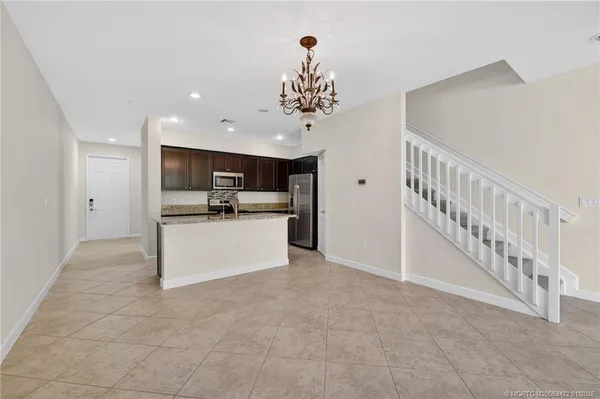 a view of kitchen with refrigerator and microwave