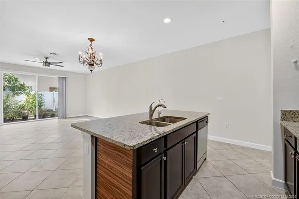 a utility room with a sink and chandelier