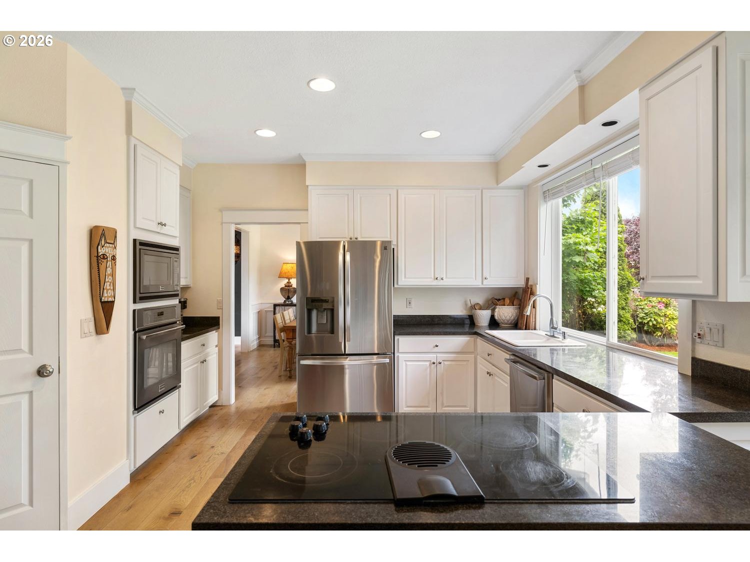 2519 Northwest 24th Circle Camas, WA 98607 - Photo 23 of 48 a kitchen with stainless steel appliances granite countertop a refrigerator oven a sink dishwasher a stove and white cabinets with wooden floor