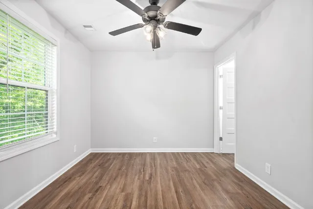 wooden floor in an empty room with a window