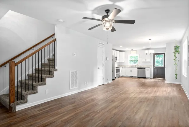 a view of an empty room and wooden floor
