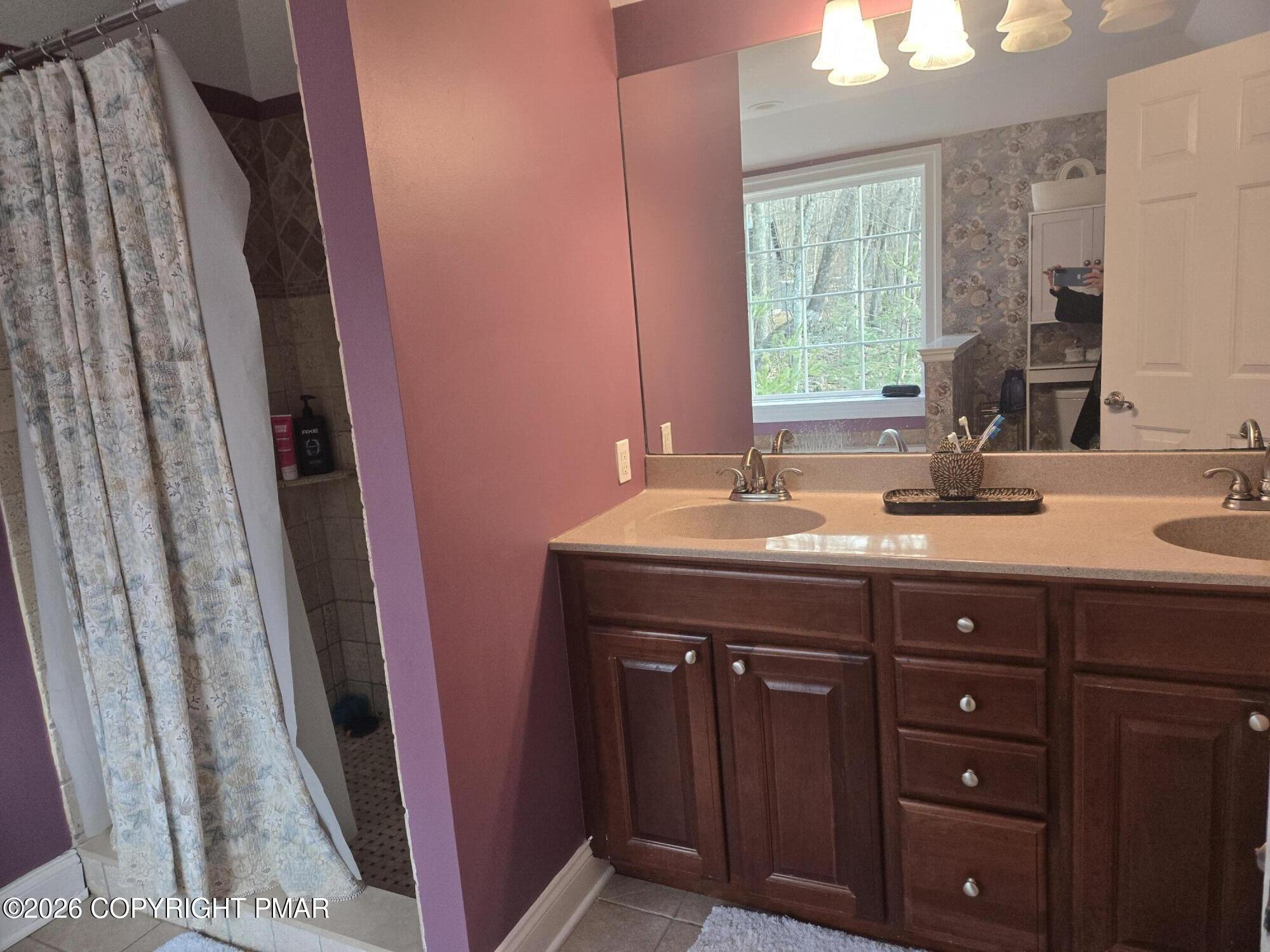 110 Crocus Lane Milford, PA 18337 - Photo 27 of 35 a bathroom with a double vanity sink and a mirror