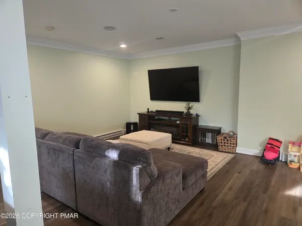 a living room with furniture and a wooden floor