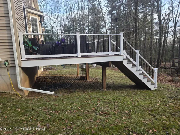 a view of wooden deck and a yard with swimming pool