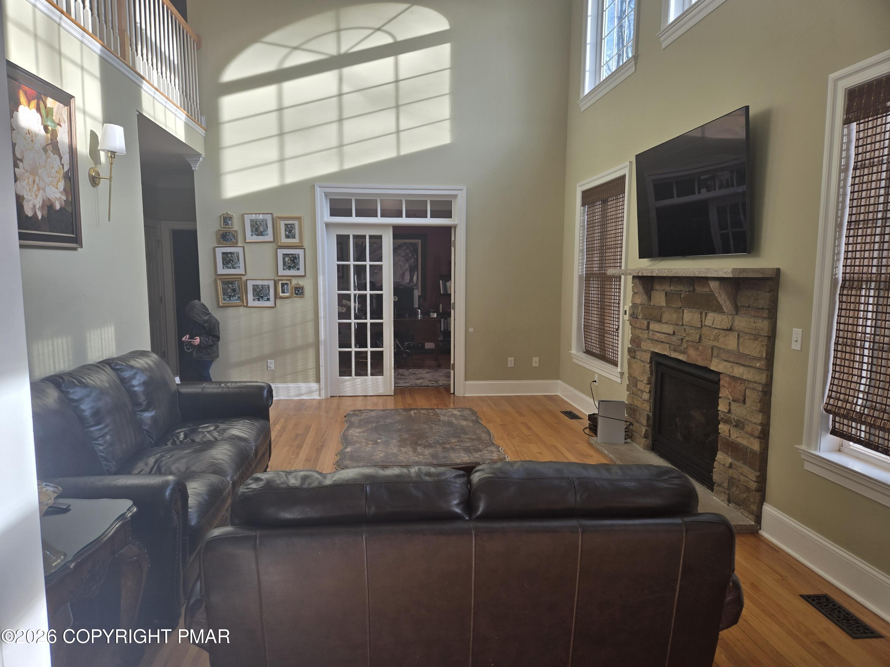 110 Crocus Lane Milford, PA 18337 - Photo 10 of 35 a living room with furniture a flat screen tv and a fireplace