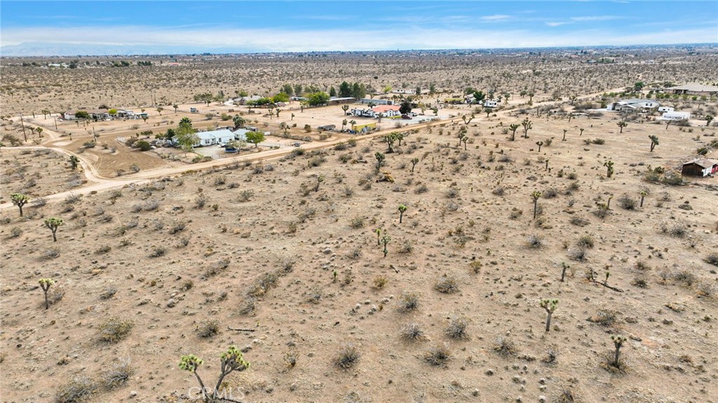 12432 La Mirada Road Phelan, CA 92371 - Photo 9 of 11 an aerial view of residential space with yard and mountain view in back