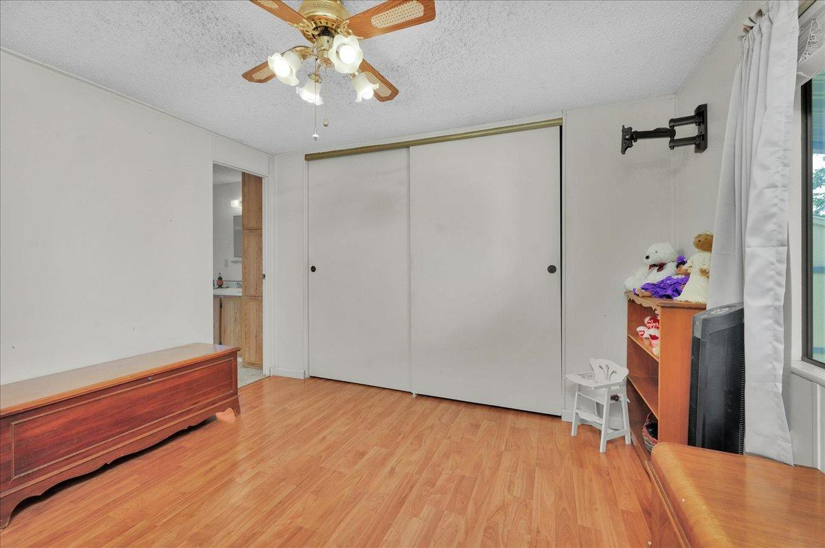 1001 Sylmar Avenue, Unit 199 Clovis, CA 93612 - Photo 14 of 50 a very nice looking room with wooden floor and a ceiling fan