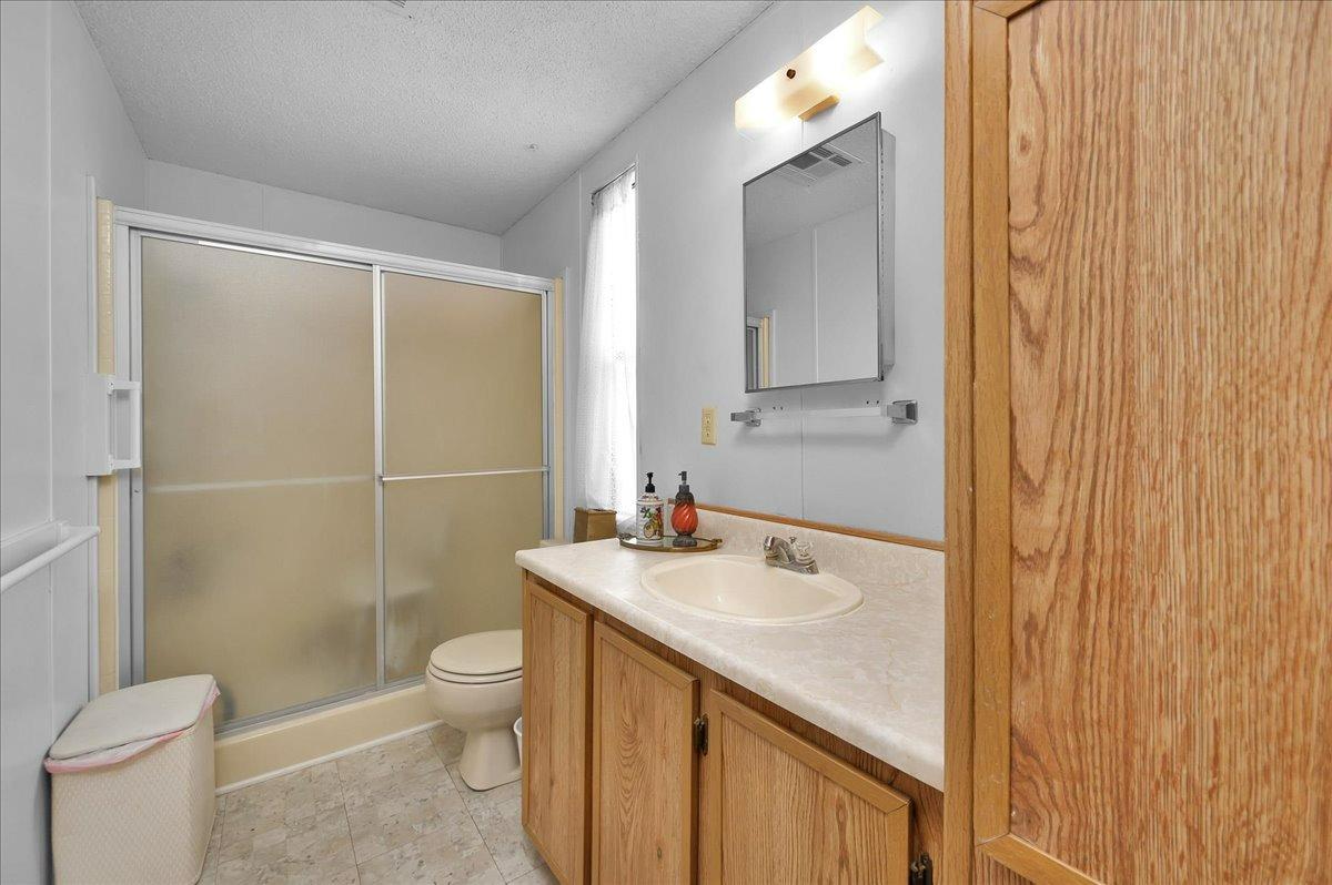 1001 Sylmar Avenue, Unit 199 Clovis, CA 93612 - Photo 16 of 50 a bathroom with a sink a toilet and shower