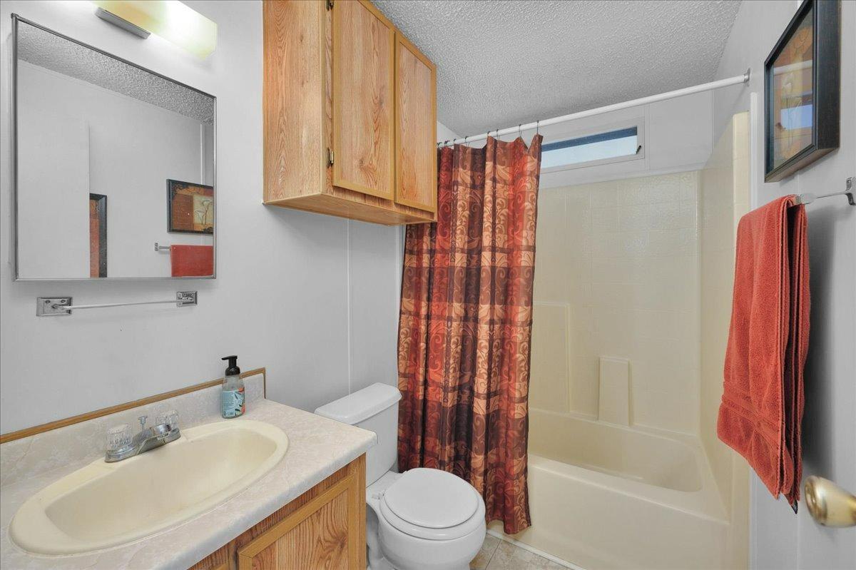 1001 Sylmar Avenue, Unit 199 Clovis, CA 93612 - Photo 17 of 50 a bathroom with a sink toilet and shower