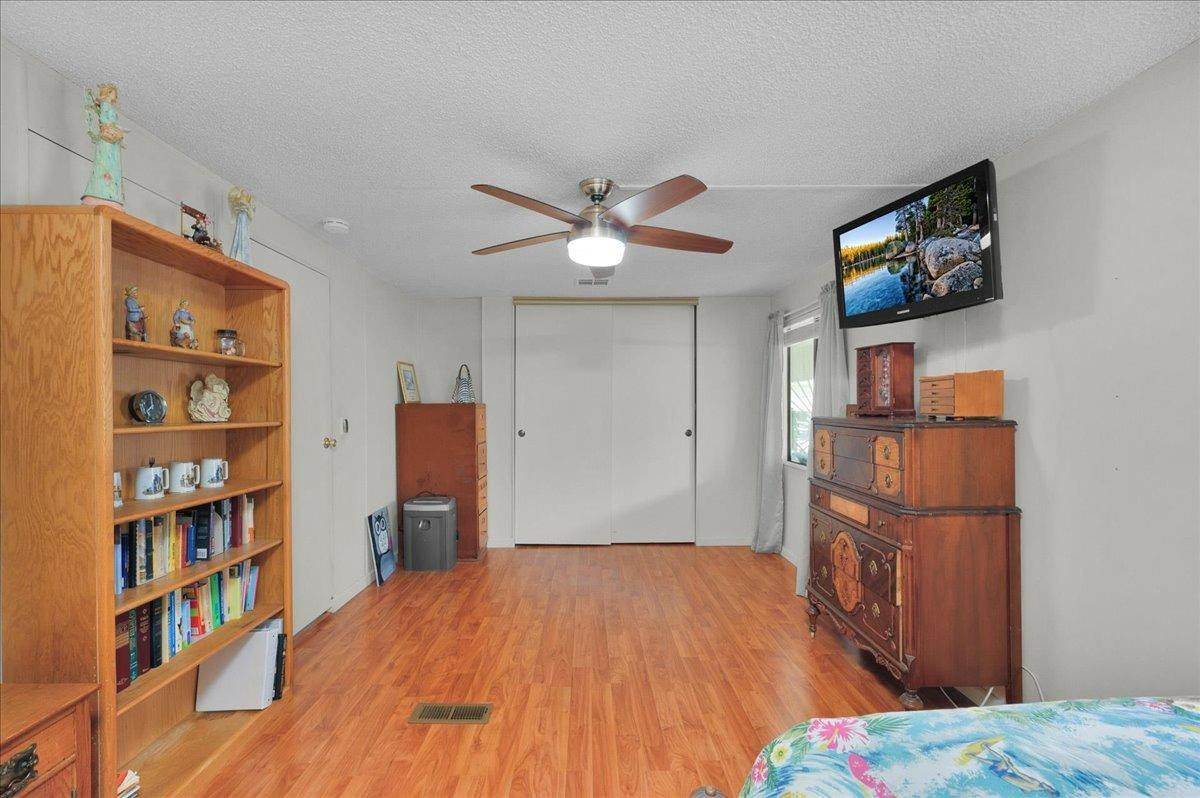 1001 Sylmar Avenue, Unit 199 Clovis, CA 93612 - Photo 20 of 50 a bedroom with a bed and a bookshelf