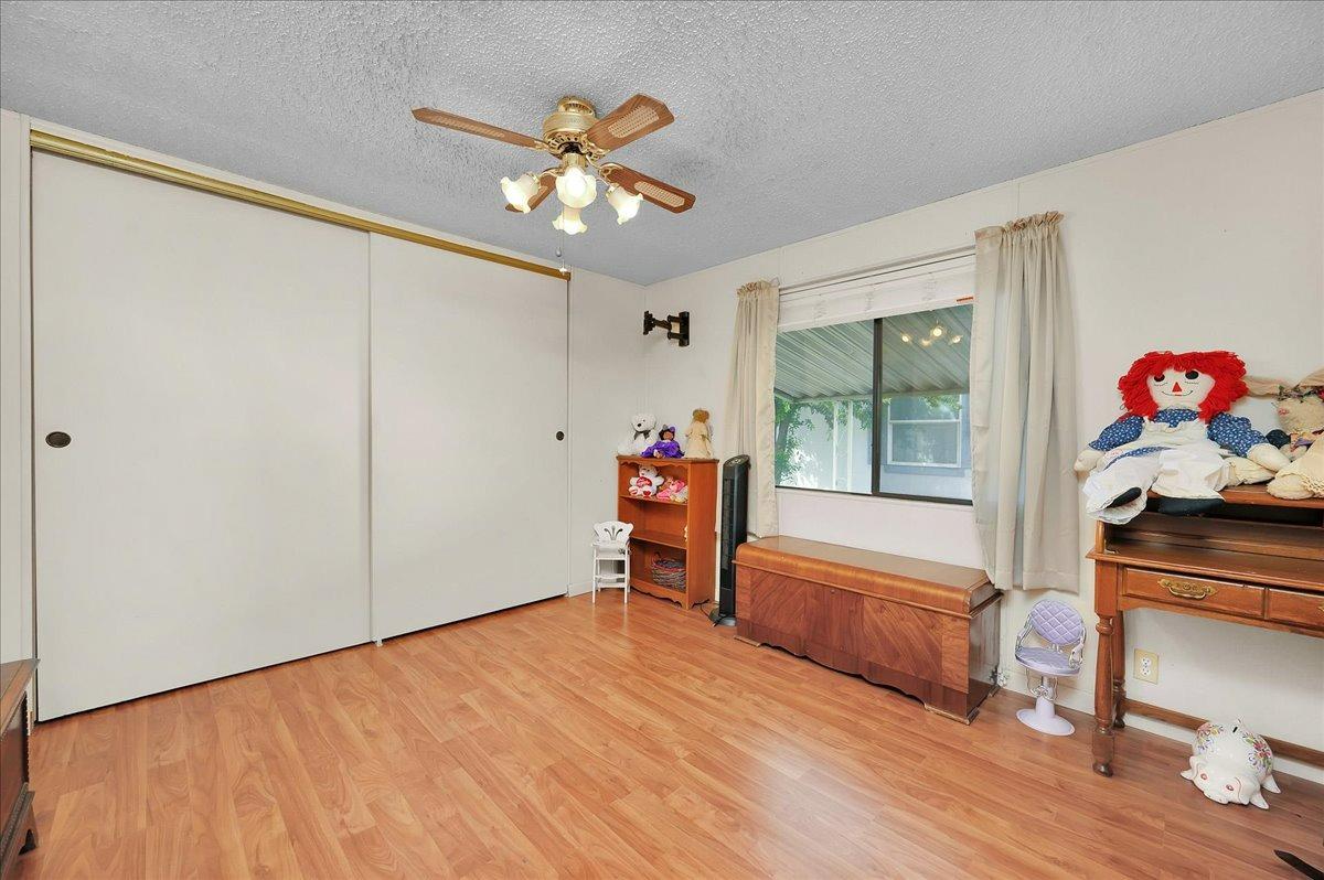 1001 Sylmar Avenue, Unit 199 Clovis, CA 93612 - Photo 21 of 50 a bedroom with a bed and a chandelier