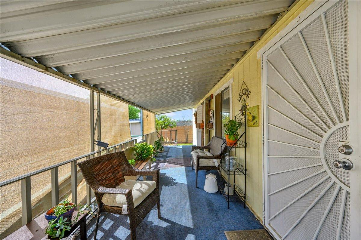 1001 Sylmar Avenue, Unit 199 Clovis, CA 93612 - Photo 23 of 50 a view of deck with table and chairs and wooden floor