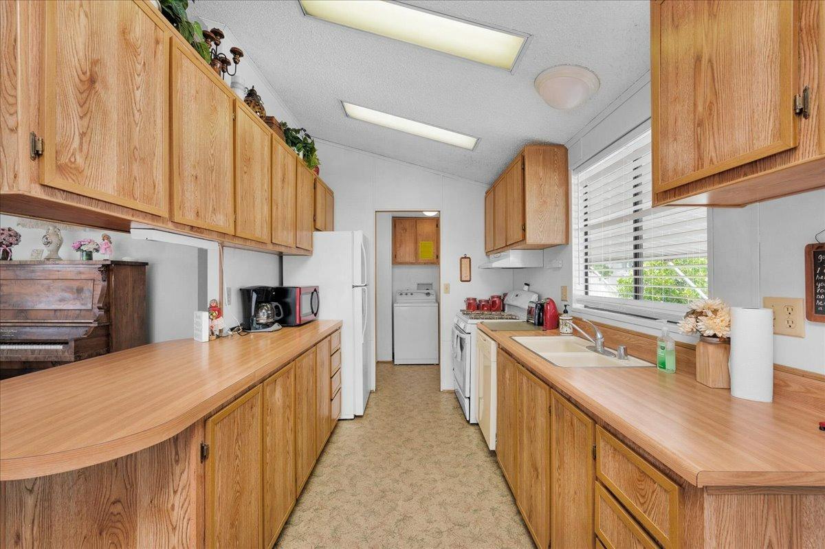 1001 Sylmar Avenue, Unit 199 Clovis, CA 93612 - Photo 5 of 50 a kitchen with stainless steel appliances a sink dishwasher a stove a refrigerator and cabinets with wooden floor