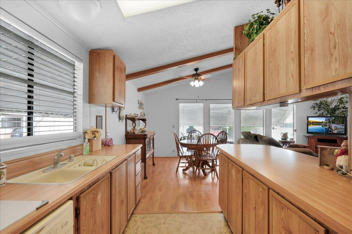 1001 Sylmar Avenue, Unit 199 Clovis, CA 93612 - Photo 6 of 50 a kitchen with counter top space a sink cabinets and appliances
