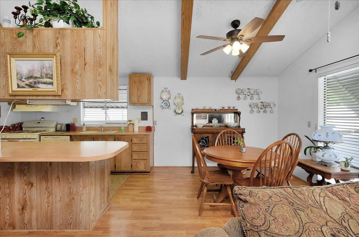 1001 Sylmar Avenue, Unit 199 Clovis, CA 93612 - Photo 8 of 50 a dining room with furniture and a chandelier