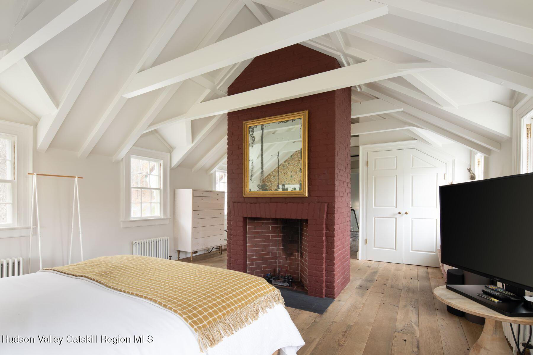 2073 Highway 82 Ancram, NY 12502 - Photo 14 of 22 a bedroom with a bed and a flat screen tv