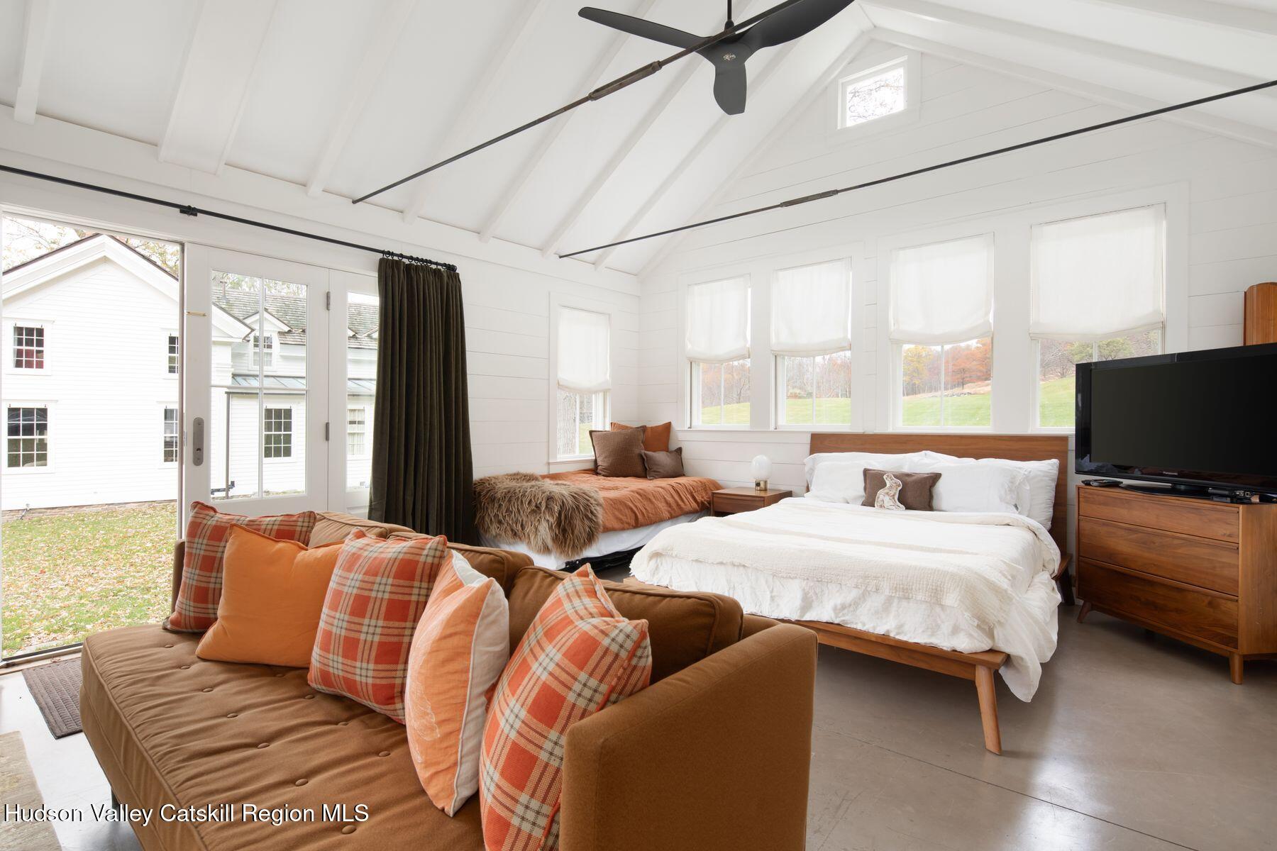 2073 Highway 82 Ancram, NY 12502 - Photo 20 of 22 a bedroom with furniture and a flat screen tv