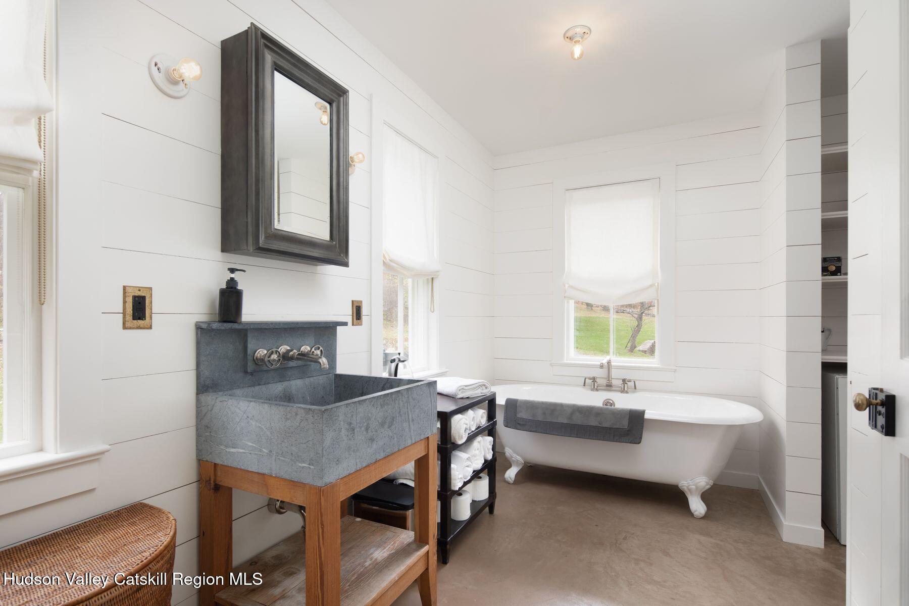 2073 Highway 82 Ancram, NY 12502 - Photo 21 of 22 a en suite bathroom with a granite countertop tub sink and mirror