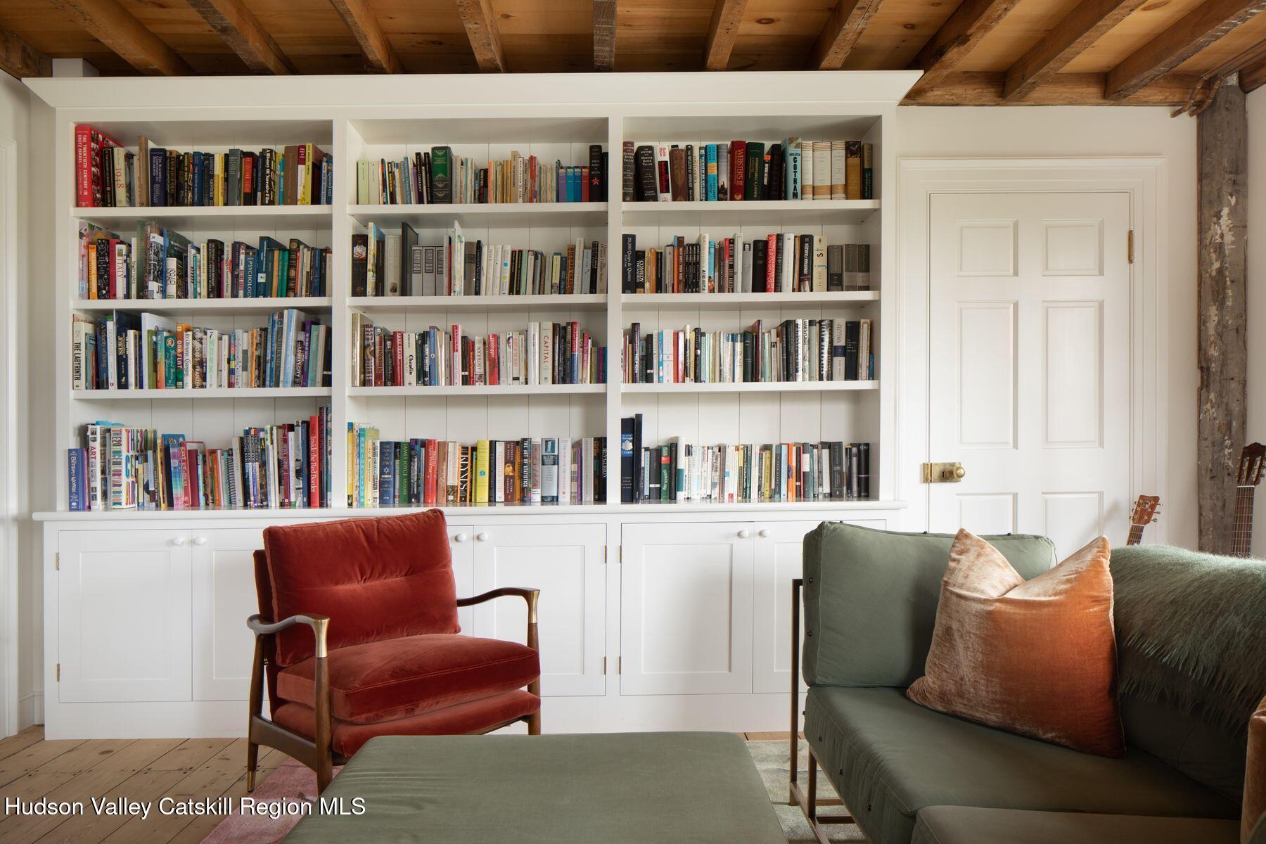 2073 Highway 82 Ancram, NY 12502 - Photo 10 of 22 a living room with furniture and a book shelf