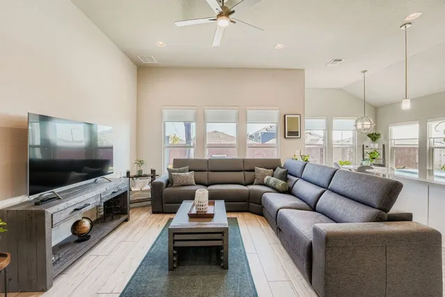 a living room with furniture and a flat screen tv