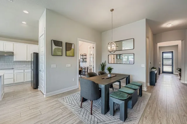 a view of a dining room with furniture and wooden floor