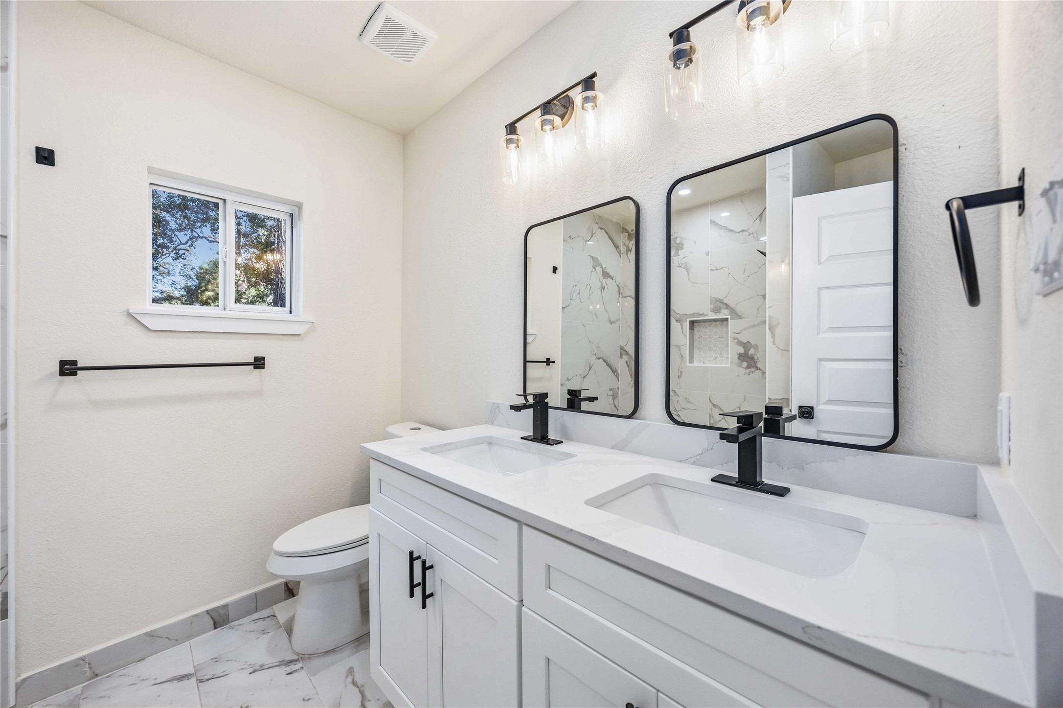 18234 Atkinson Lane Conroe, TX 77384 - Photo 14 of 30 a bathroom with a sink a toilet and a mirror