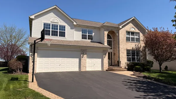 a front view of a house with a yard and garage