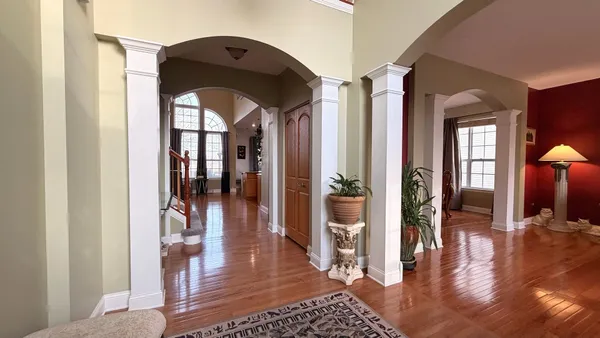a kitchen with stainless steel appliances granite countertop lots of counter top space and wooden floor