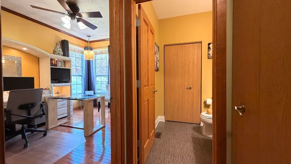 a bedroom with a bed dresser and a flat tv screen