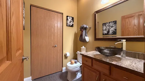 a view of staircase with lots of frames on wall and a window