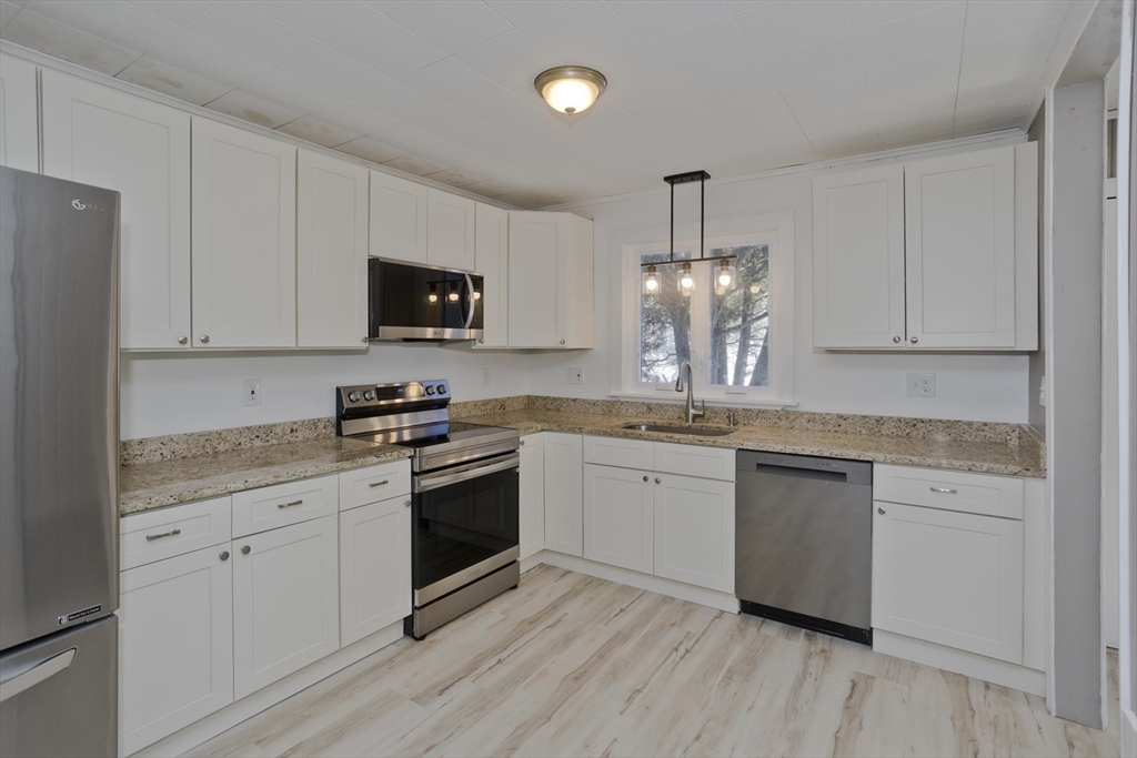 16 Knightville Dam Road Huntington, MA 01050 - Photo 3 of 40 a kitchen with granite countertop white cabinets and stainless steel appliances
