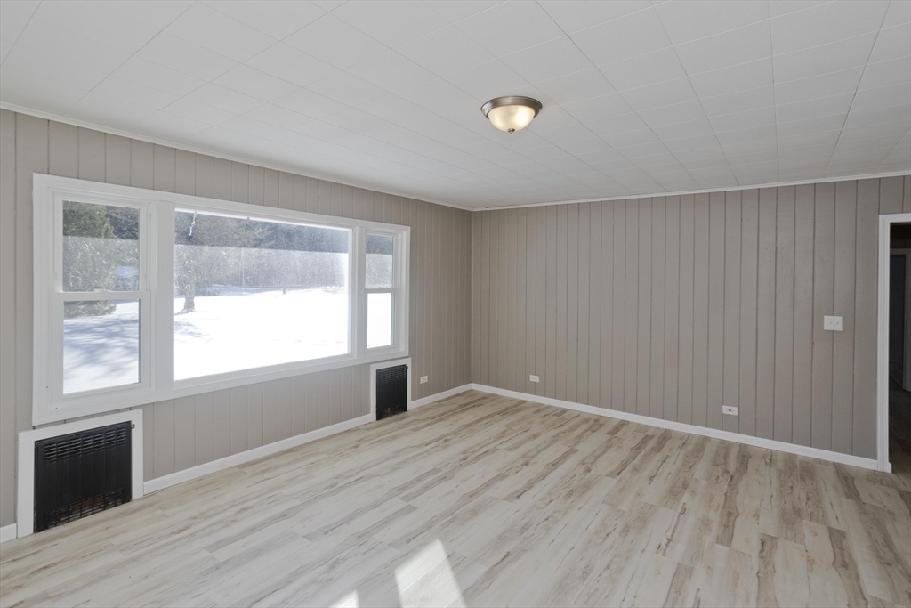 16 Knightville Dam Road Huntington, MA 01050 - Photo 6 of 40 an empty room with wooden floor and windows