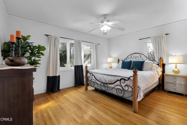 a bedroom with a bed and a potted plant