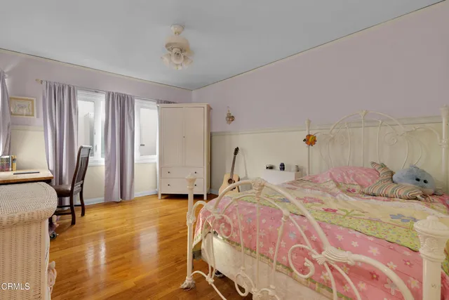 a bed sitting in a bedroom next to a window