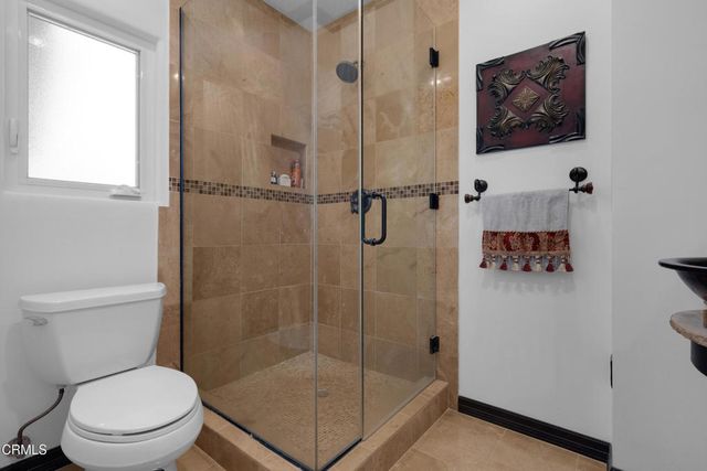 a bathroom with a toilet and a shower