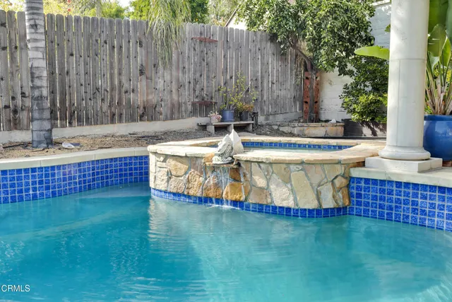 a view of outdoor space with swimming pool and trees in the background