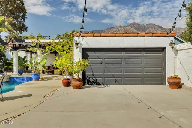 a view of the street with potted plants