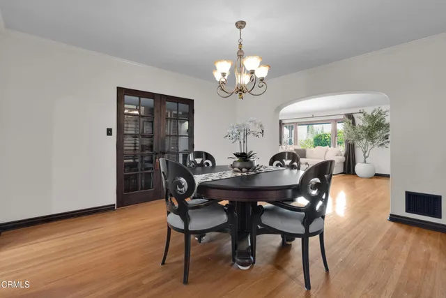 a view of a dining room with furniture wooden floor and chandelier