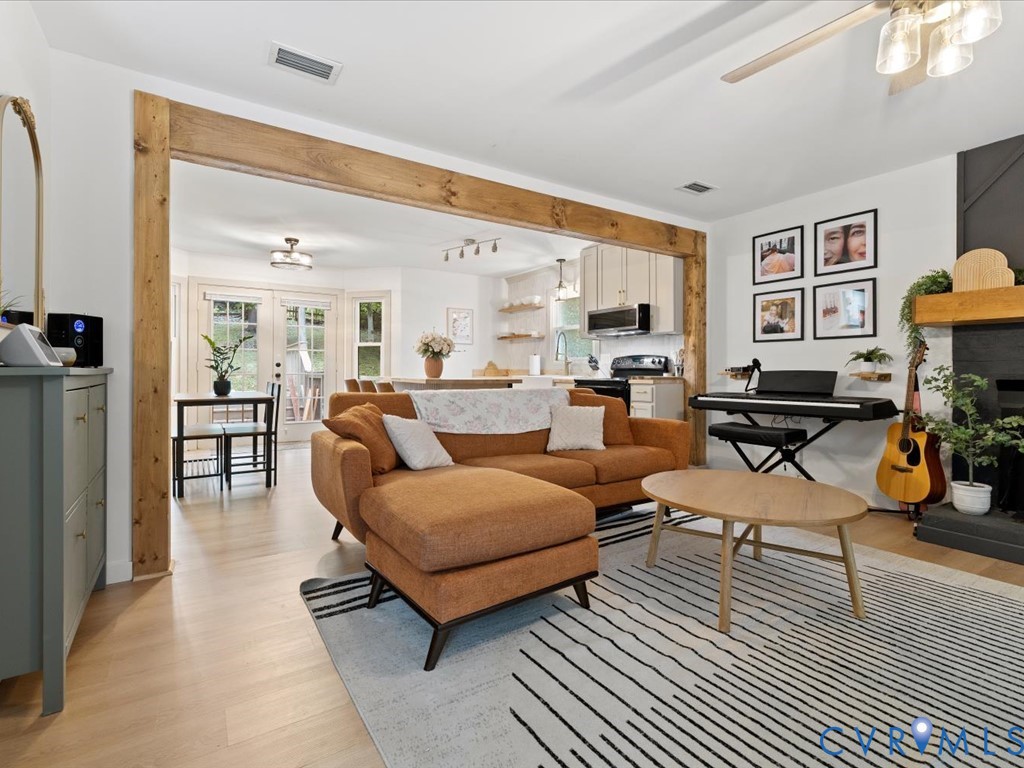 a living room with furniture a table and a large window