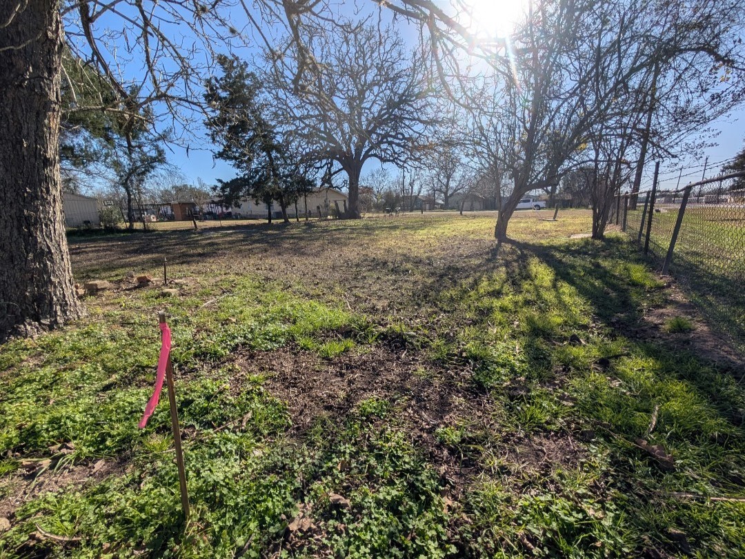 113 South Santa Fe Road Somerville, TX 77879 - Photo 6 of 6 a backyard of a house with trees and wooden fence