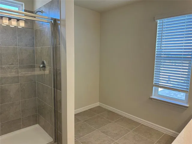 a bathroom with a glass door shower
